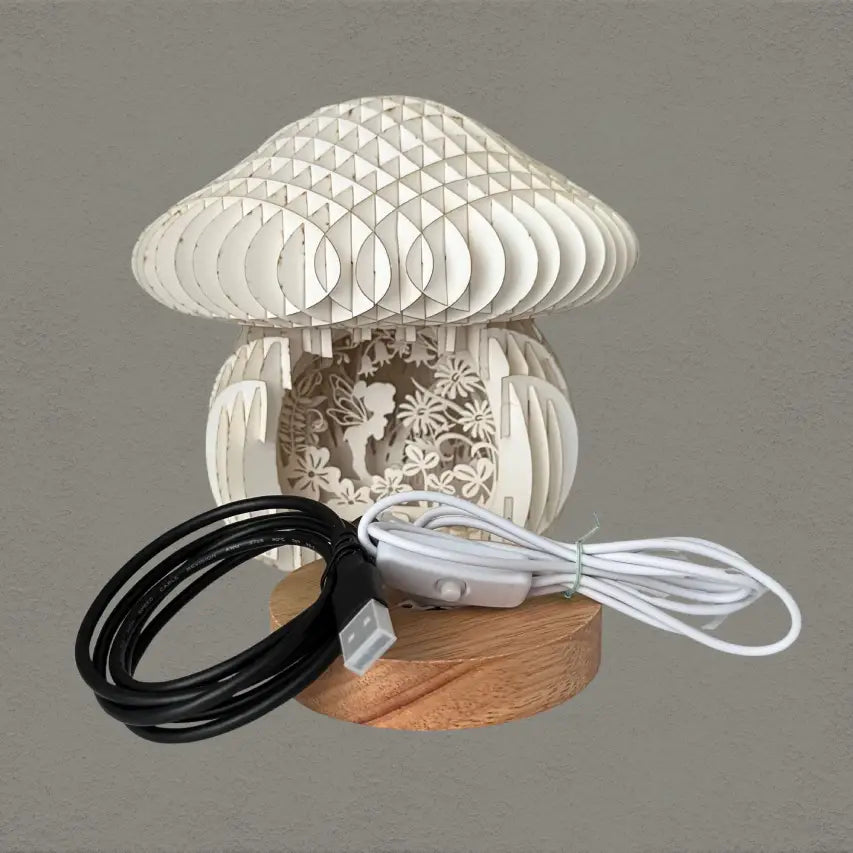 mushroom fairy lantern with LED light base and extender cord on a grey background.