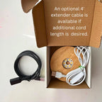 a black cable on a light background with a box holding a light base with cord and text that says an optional 4' extender cable is available.