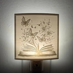 Lithophane nightlight with an open book with butterflies and flowers on a light yellow background