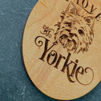 keychain with engraved dog illustration and text 'I love my Yorkie' on a blue textured background