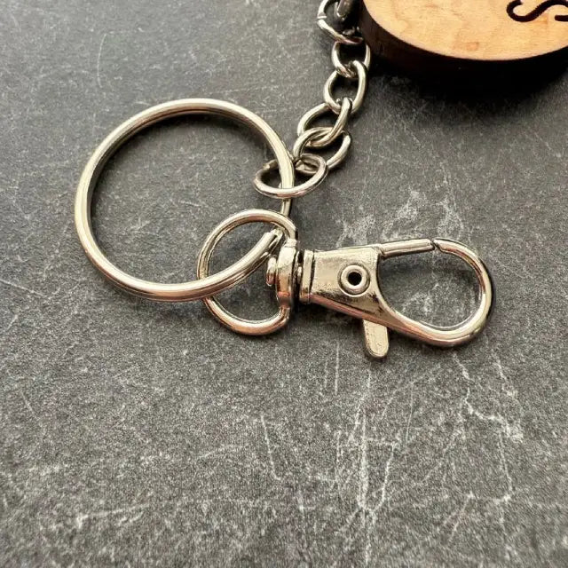 Metal keychain with a clasp on a gray surface