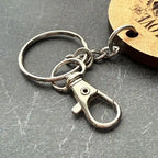 silver lobster clasp with keyring on dark grey background